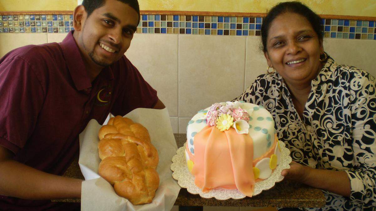 PEMBROKE PINES: Imran Baksh and his mother, Najibe Baksh, show off plat (braided bread) and a decorated cake at their Sheiks Bakery & Cafe.
