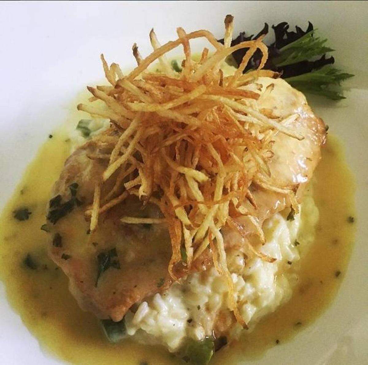 Risottos, a specialty of Hernandez, come in many colors, such as this one served as a bed for the fish of the day.