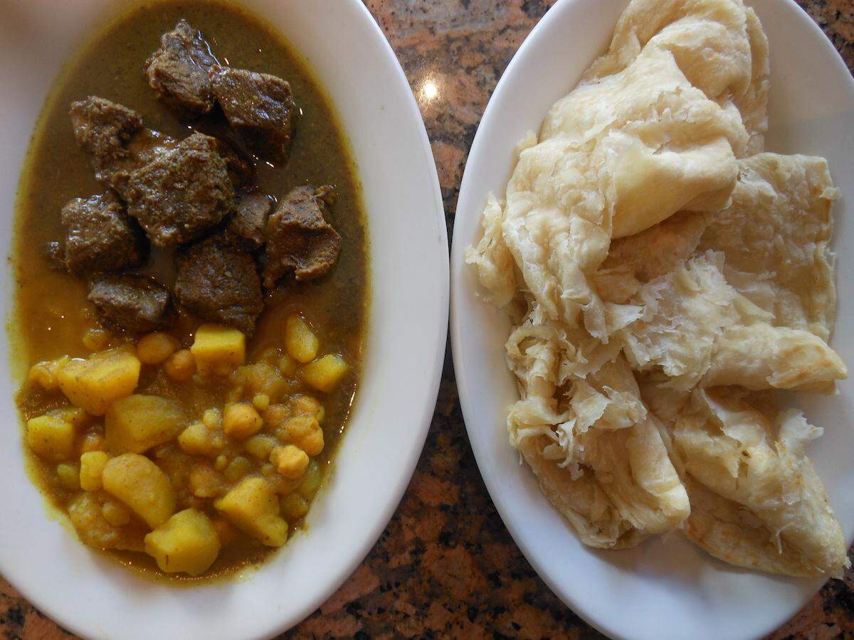 Goat curry with potato and chickpea curry with buss up shut bread at Chokas