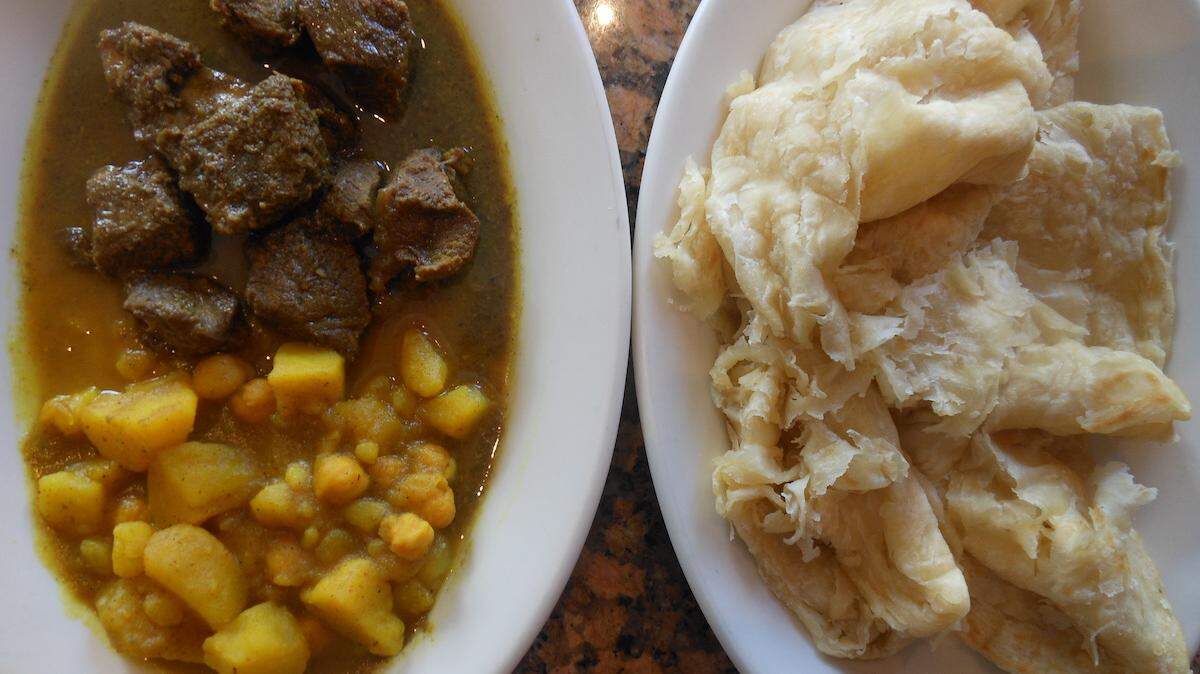 Goat curry with potato and chickpea curry with buss up shut bread at Chokas
