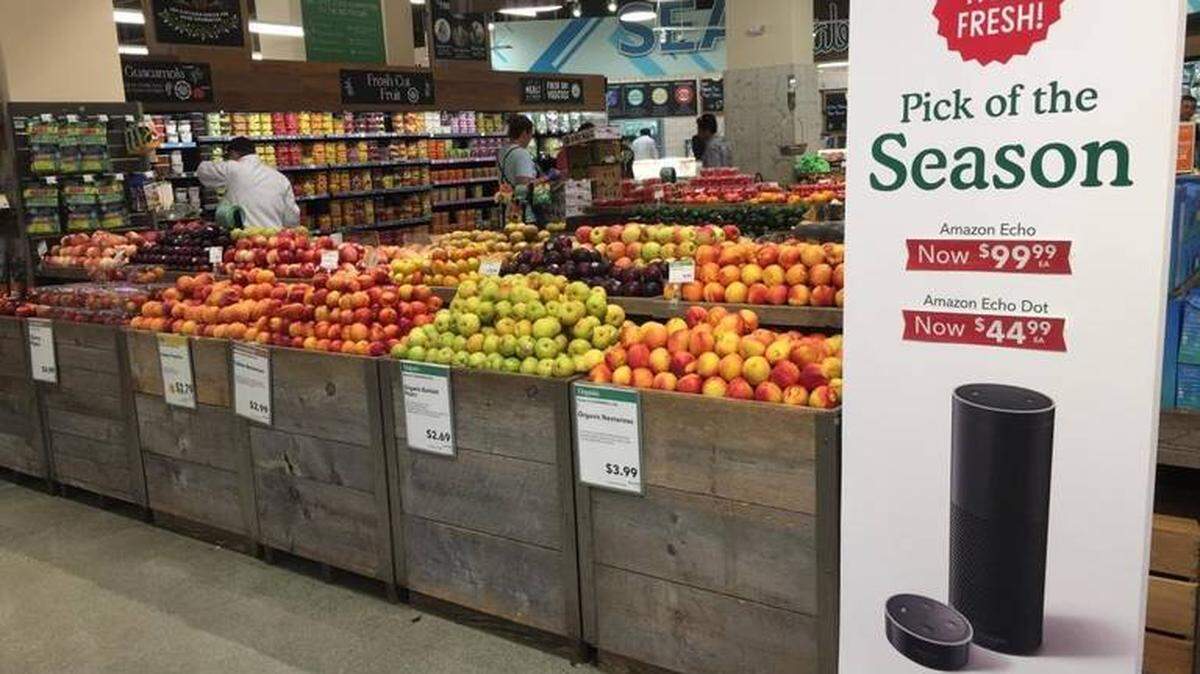 Amazon slashed prices at Whole Foods Markets on many grocery store staples to mark the completion of its $13.7 billion purchase Monday. Signs co-branded Whole Foods and Amazon noted previous and new, lower prices on many of those items, and in-store shoppers could even purchase an Amazon Echo in many stores.