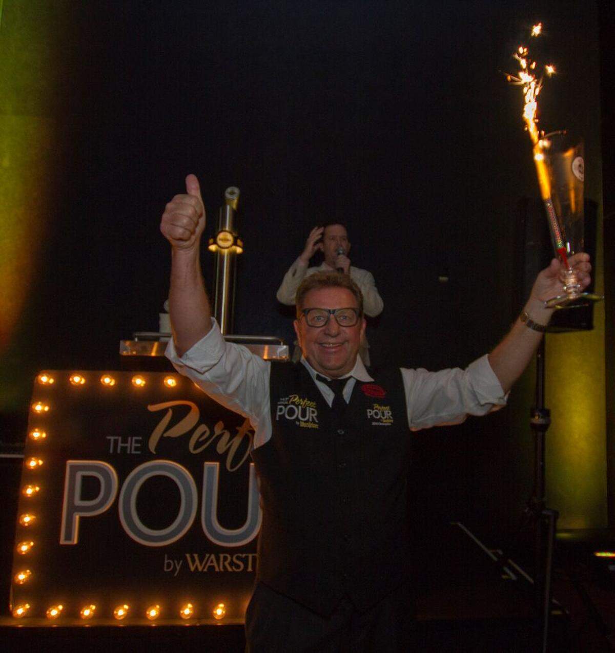 Harald Neuweg proudly displays his perfect pour that won him the Warsteiner Perfect Pour competition. (Handout)