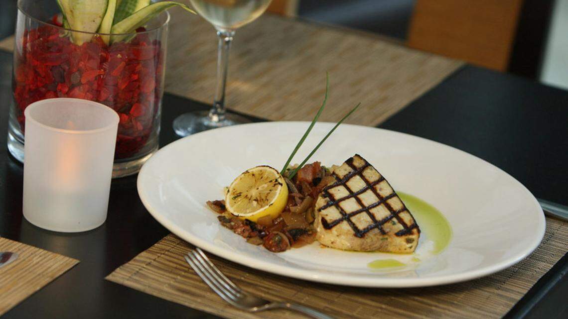 Grilled Swordfish Steak and Fire Roasted tomatoes with Triple olive chutney.