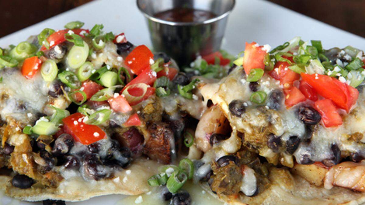 Huevos Rancheros $8.00. Two toasted corn tortillas layered with black beans, green chili, potatoes and two fried eggs topped with jack cheese and roasted tomato salsa.