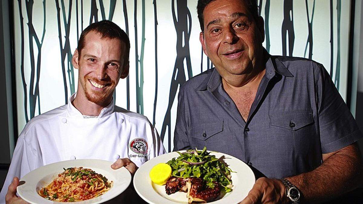 LIGHTHOUSE POINT: Ernie’s Italian Chophouse chef Gary Wood, left, displays his spaghetti All’Amatriciana while owner Ernie Patti shows off the grilled octopus