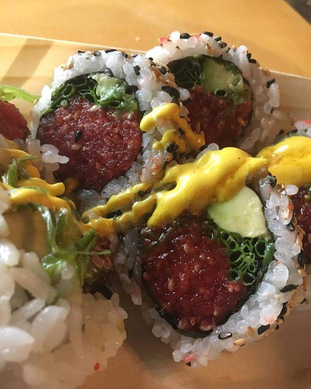 The Angelo Roll, with Spicy tuna, avocado, chives, nori chips, wakame;smoked ponzu and aji amarillo on top.