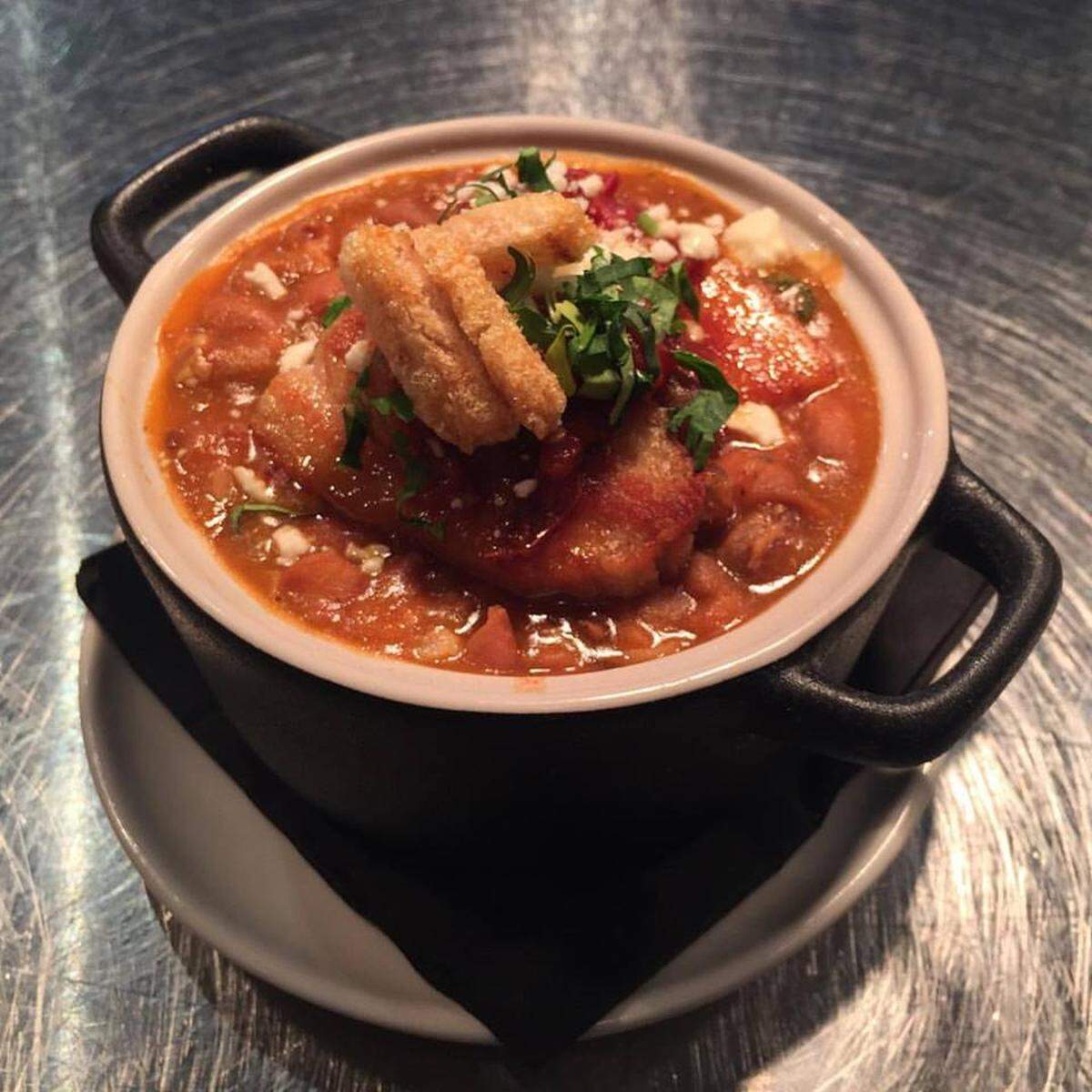 The charros olla combines meaty pork belly and cowboy beans in a sauce heightened with pasilla Oaxaca chile to make for a hearty and satisfying dish.