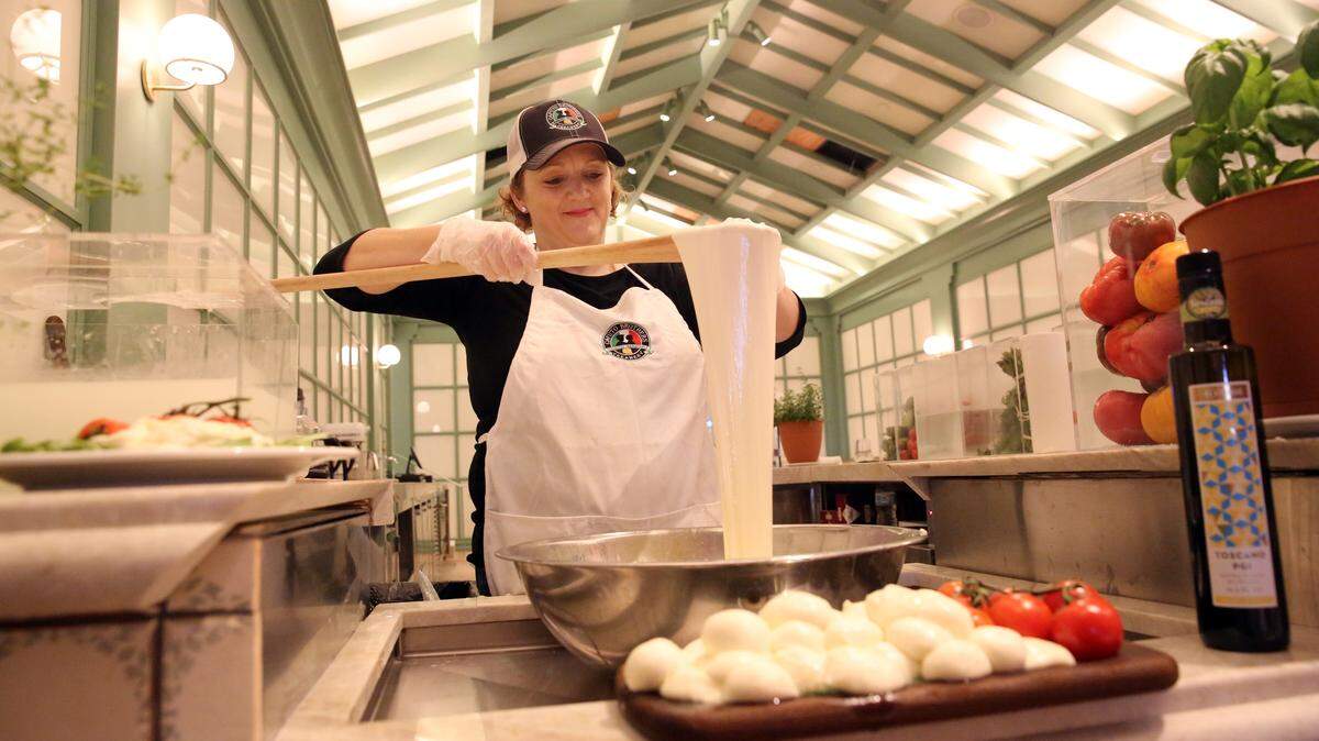 Rynn Caputo works with a piece of fresh hand-pulled mozzerella at Stagionale, one of the 14 different Italian eateries inside of La Centrale at Brickell City Centre.