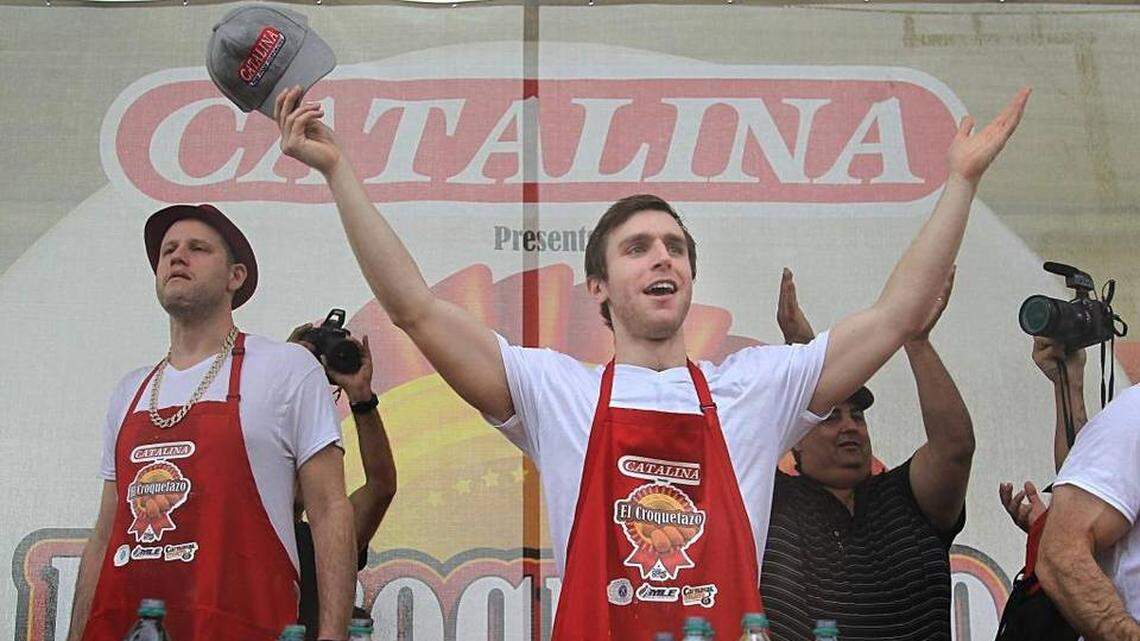 Carmen Cincotti lifts his arms in victory after eating 158 croquetas to win the World Championship Croqueta Eating Contest presented by Catalina at the El Croquetazo event during Calle Ocho on Sunday, March 12, 2017.