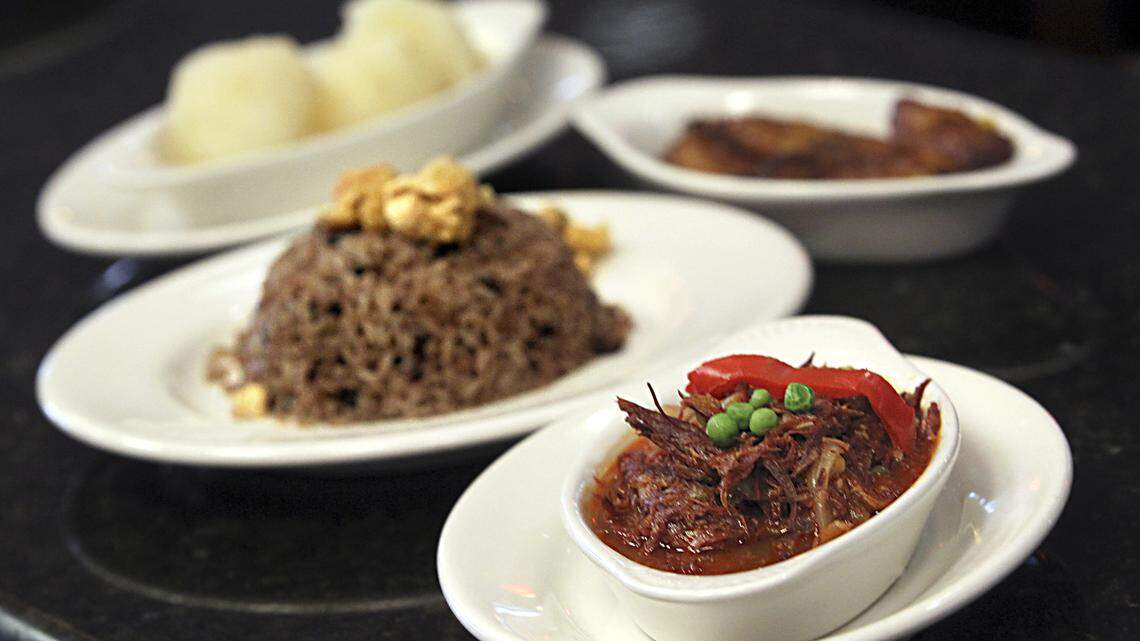 -Clockwise- Tasajo" ( dried beef Cuban style) with moros ( white rice and black beans mixed),  yuca and sweet plantain one of the many dishes on the menu at restaurant Molina's Ranch Restaurant in Hialeah