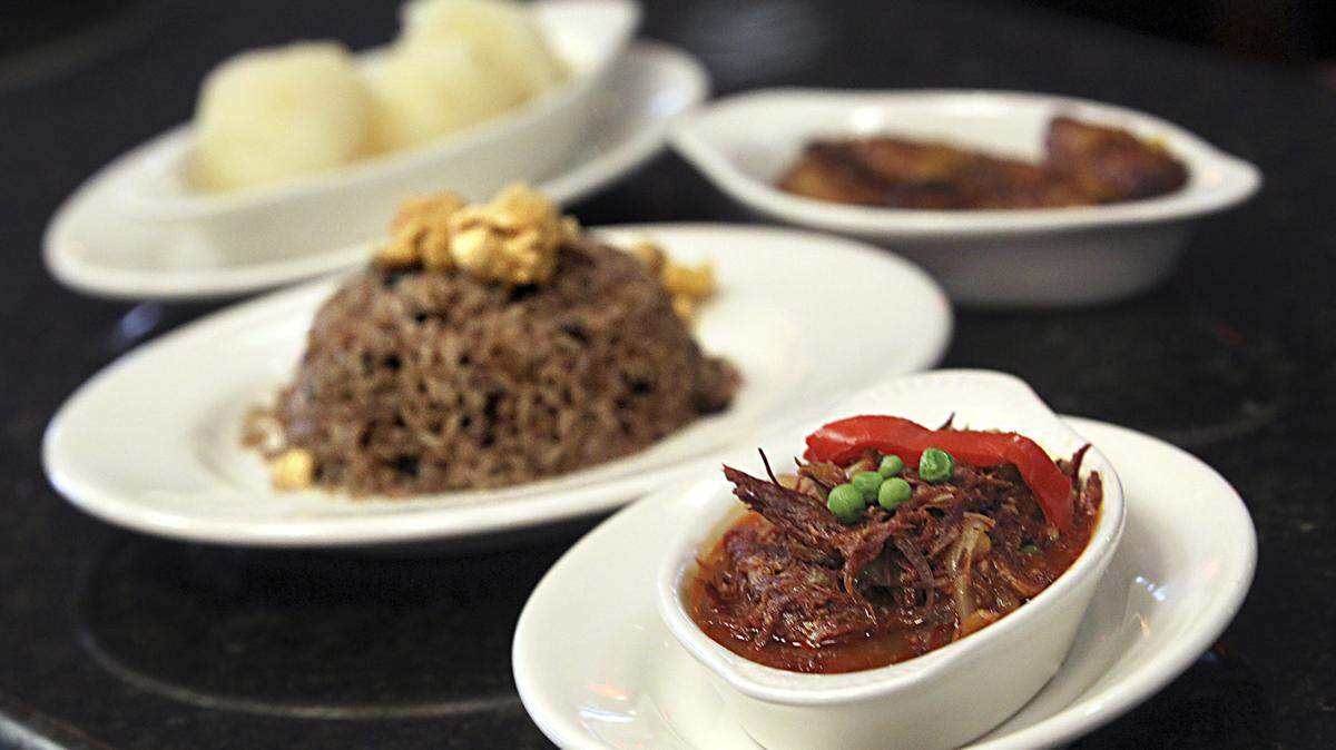 -Clockwise- Tasajo" ( dried beef Cuban style) with moros ( white rice and black beans mixed),  yuca and sweet plantain one of the many dishes on the menu at restaurant Molina's Ranch Restaurant in Hialeah