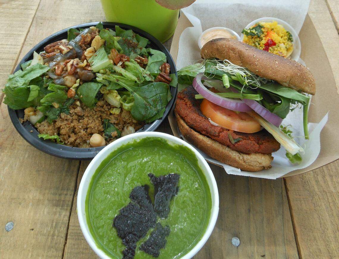 Middle Eastern bowl with ground turkey on a bed of couscous with chickpeas, grilled eggplant and toasted walnut topped with salt greens at Smart Bites.