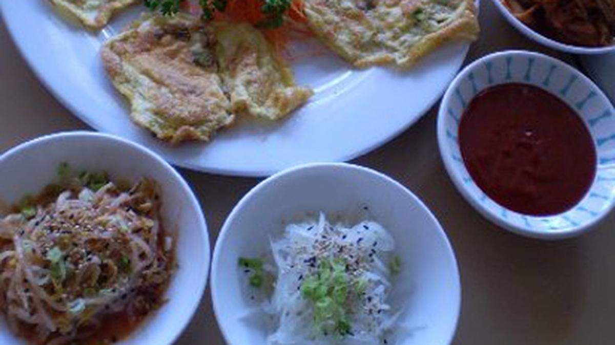 Shilla's Korean fish and scallion egg pancakes with kim chee and banchan (side dihes). Photo: Linda Bladholm