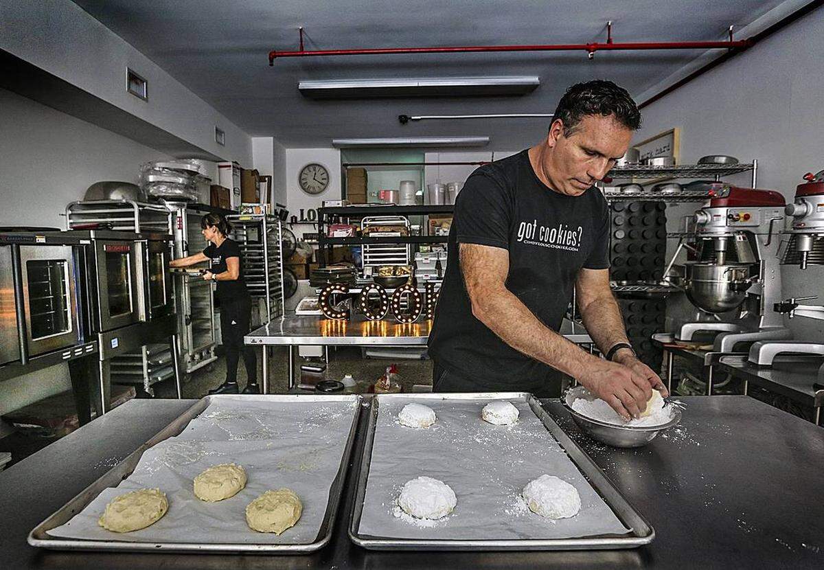 Cindy Kruse (back left), with her partner Eric Paige, turned a 25-year career as a pastry chef at high-end restaurants into baking some of Miami’s most delicious cookies at her Cindy Lou’s Cookies.