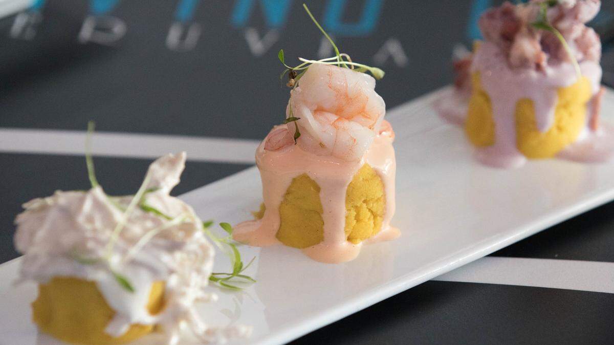 Several different kinds of meats top the potato causas at Divino Ceviche.