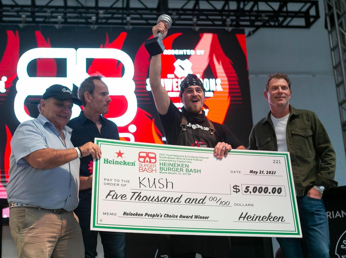 Kush Chef Leo Osorio, center, celebrates after winning the $5,000 Heineken People’s Choice Award at the South Beach Wine & Food Festival’s Burger Bash in Miami Beach, Florida on Thursday, May 20, 2021.