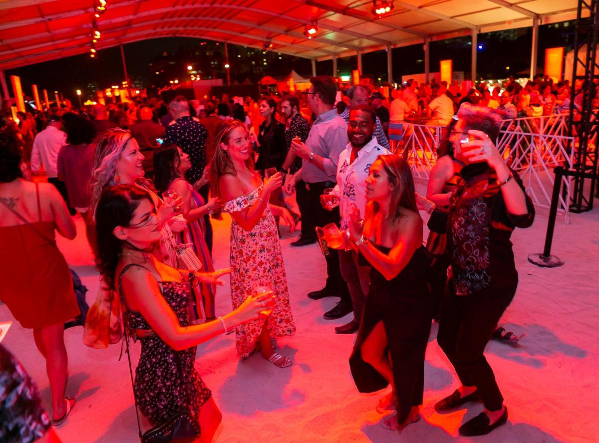 Guests dance as they attend the South Beach Wine and Food Festival Italian Bites on the Beach.