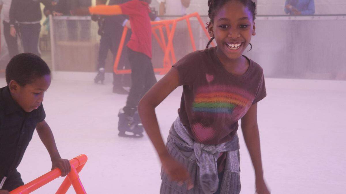 Kids from the Lotus House test out the rink.