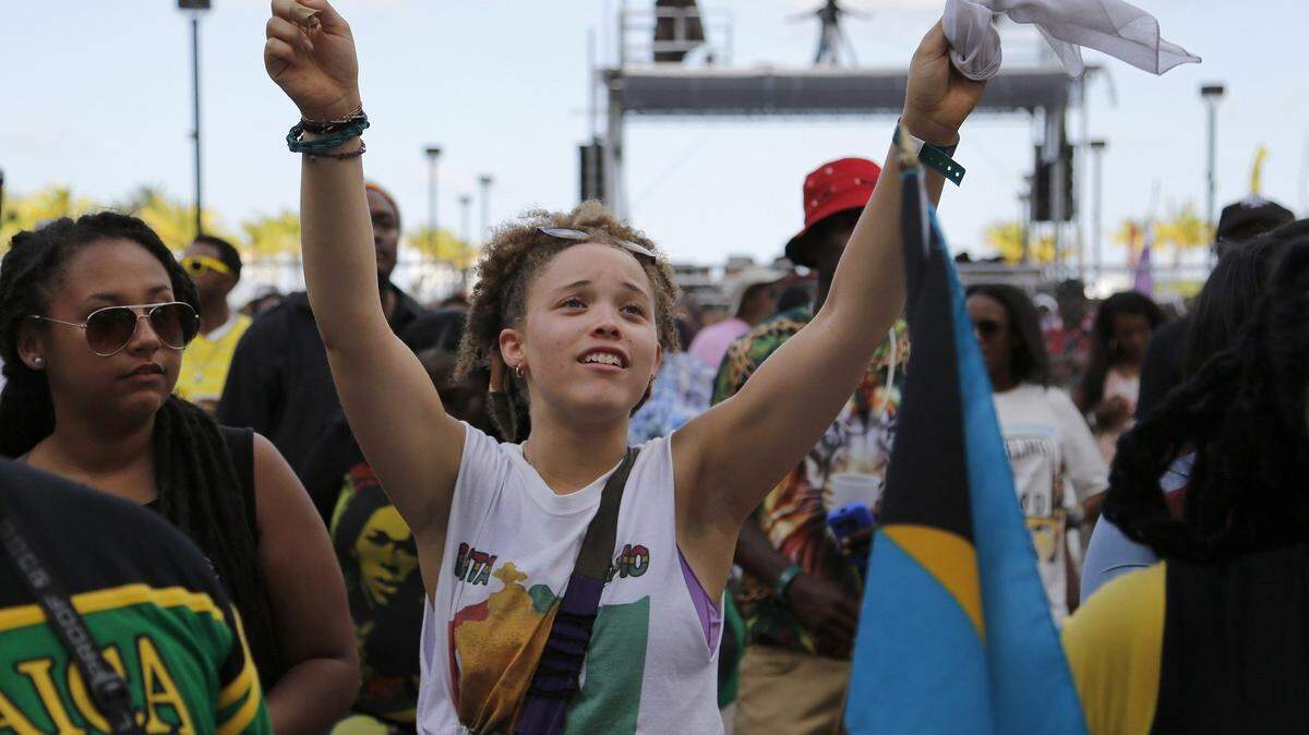 Sydney Jackson, center, 16, lift her arms in the air as she joins many in dancing to reggae music at the Best of the Best.  Revelers danced to reggae and soca music in the 9th year, the Best of the Best concert was held in downtown Miami inside Bayfront Park on Sunday, May 24 2015.