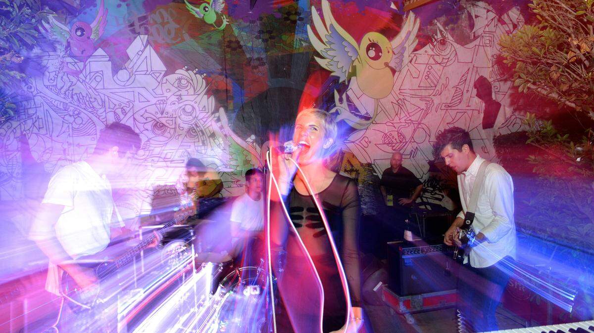 Yacht's Claire Evans sings an experimental infused performance for III Points Music, Art and Technology Festival during the DFA Records BBQ at Cafeina in Wynwood, Miami, Fla., on Saturday, Oct. 5, 2013. Evans entertained guests by walking through the crowd, swinging the mic and wrapping it around her body for a fun-filled show.