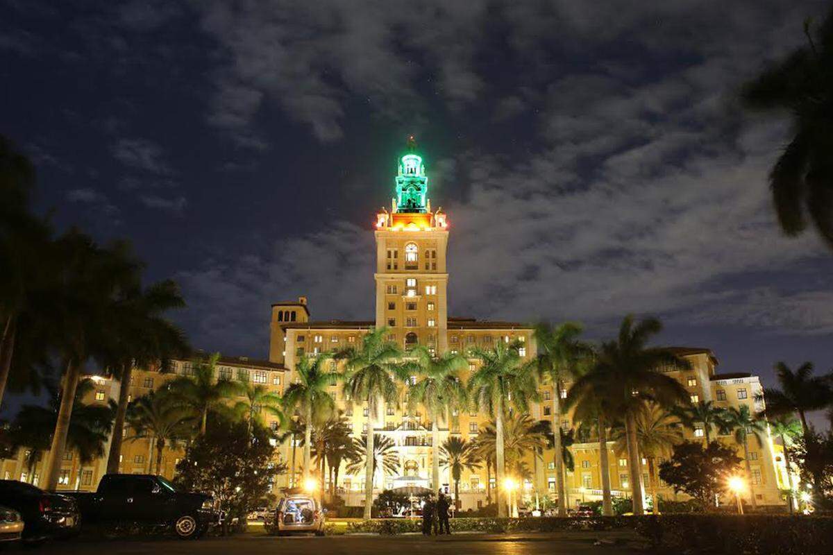 The venerable Biltmore Hotel in Coral Gables illuminated its peak with the University of Miami's colors, green and orange, in honor of the school's new president, Dr. Julio Frenk who was inaugurated January 29, 2016. (Eduardo Valdes/Miami Herald)