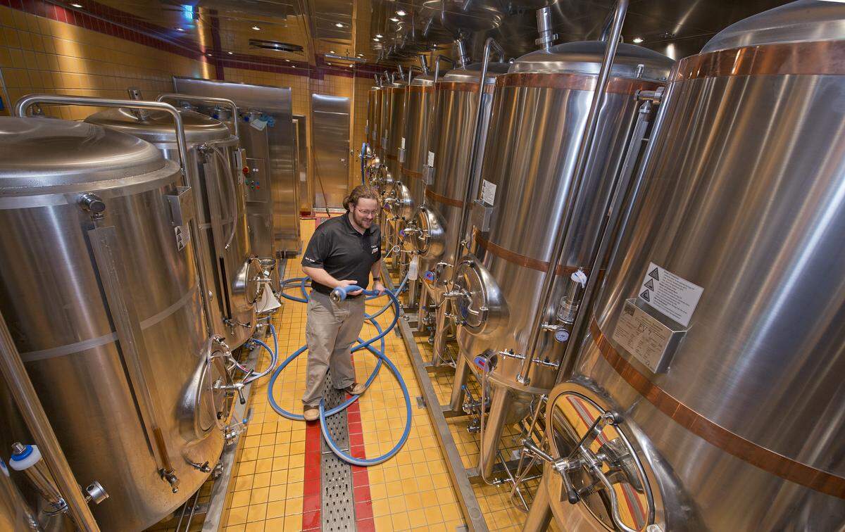Carnival Vista Brewmaster Colin Presby tends to fermentation tanks in the RedFrog Pub onboard Carnival Vista. Photo by Andy Newman/Carnival Cruise Line