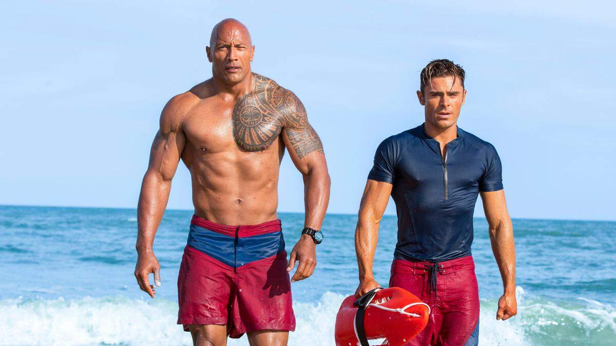 Dwayne Johnson, left, and Zac Efron in a scene from, "Baywatch," in theaters May 25.