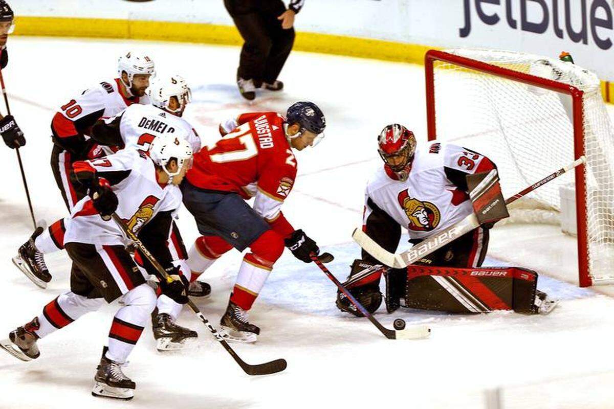 Florida Panthers center Nick Bjugstad - he's the guy in red - takes a shot against the Ottawa Senators.