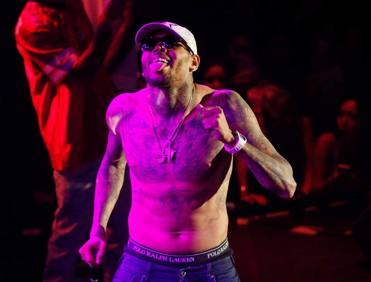 FILE - In this July 25, 2015 file photo, Grammy award-winning singer Chris Brown performs at a club in Macau. Brown canceled plans for a Down Under tour Wednesday, Dec. 2, 2015 after Australian authorities had earlier warned the troubled R&amp;B singer they were likely to refuse him a visa because of his criminal conviction for assaulting pop star Rihanna. (AP Photo/Kin Cheung)