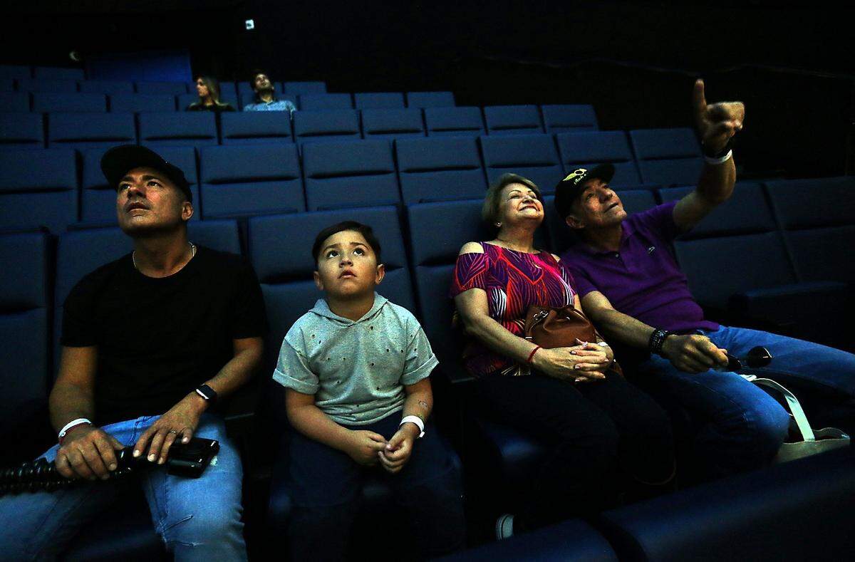 Jorge Bernal, his son Lucas Bernal 7, and grandparents Senda Bernal and Roberto Gonzalez get an early seat to enjoy the show in the Planetarium  during the long-awaited opening of the Phillip and Patricia Frost Museum of Science on Sunday, May 7, 2017.