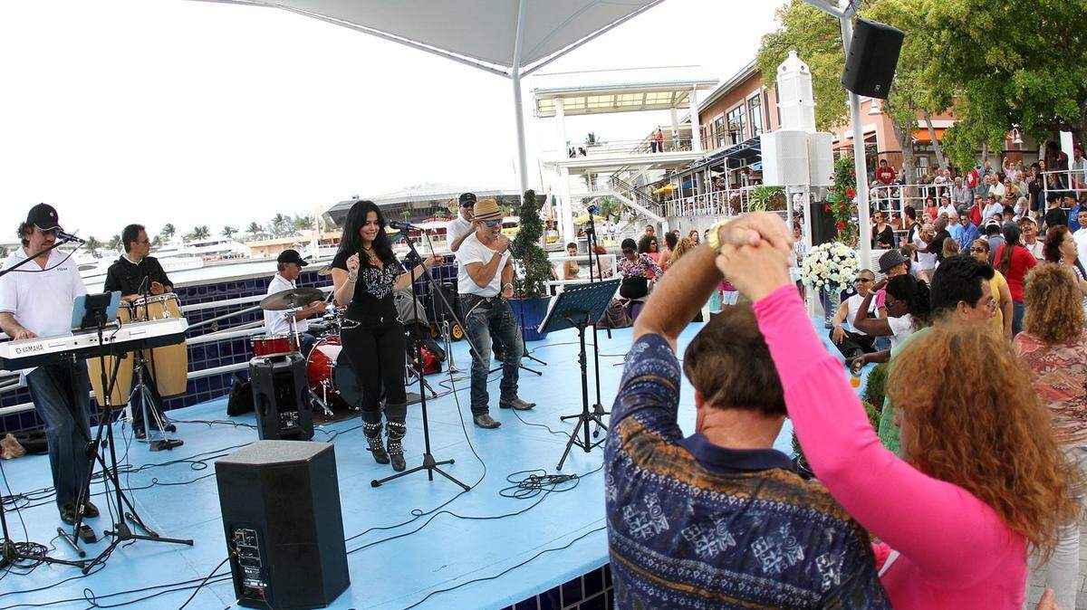Locals and tourists dance side by side to the music of the Hialeah Sound Machine in front of Biscayne Bay as Bayside Marketplace in Downtown Miami celebrates its 25th Anniversary on Saturday, April 14, 2012. The day featured traditional dance and music performances from around the world.