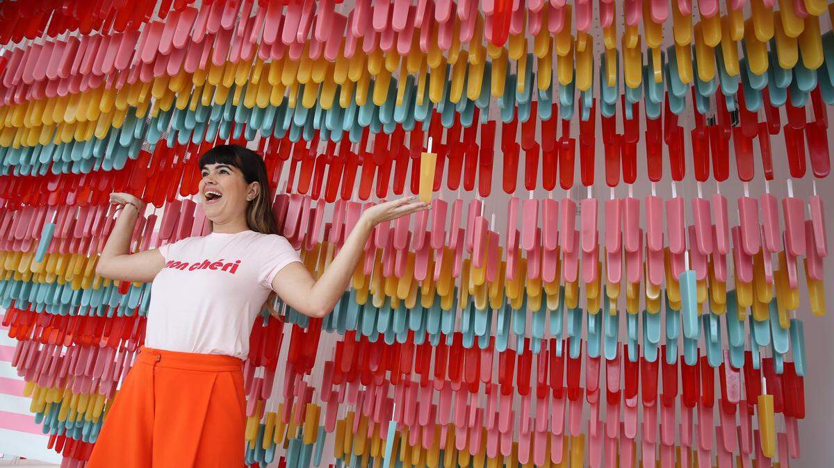 The Museum of Ice Cream has opened its fourth U.S. location, this time on Collins Ave. in Miami Beach. The museum offers guests the chance to taste, smell, swing and even swim in all things ice cream. Kathy Buccio with Ocean Drive Magazine, plays with colorful popsicles that are suspended upside down from the ceiling, on Thursday, Dec. 7, 2017. (Emily Michot/Miami Herald)