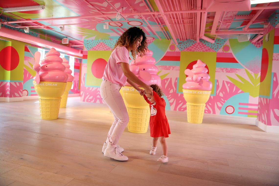 Gabrills Loo, dances in the Fan-tastic room with Valentina Pereda, 2, Thursday, Dec. 7, 2017 at The Museum of Ice Cream on Collins Ave. in Miami Beach. Each room insode the four floor, art deco museum has a different, colorful, ice cream theme. (Emily Michot/Miami Herald)