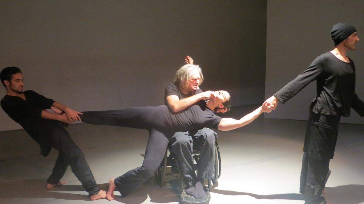 Dancers Robert Seller (left) and John Beauregard (center in chair) with choreographers Katrina Weaver (middle) and Juan Maria Seller (right) of “Scrutiny: The World Gone Astray,” an integrated dance performance making its Miami debut at the Miami-Dade Auditorium on Thursday, May 11.
