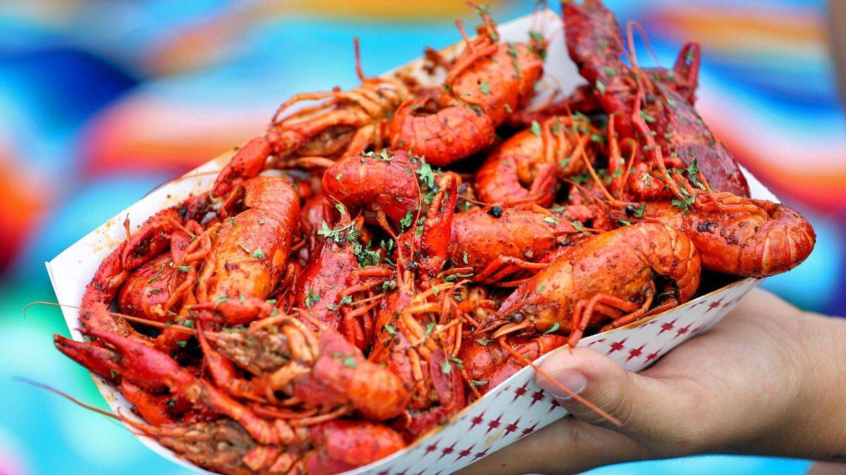 A customer sits with a plate of crawfish at the 12th Annual Deering Seafood Festival on the Bay on Sunday, March 20, 2016