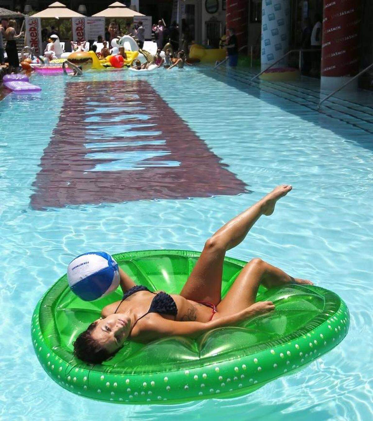 Promo and cam models mingle, dance, sunbathe and are photographed at poolside Wednesday at the SLS South Beach hotel during the CamCon trade show in Miami Beach. CARL JUSTE cjuste@miamiherald.com