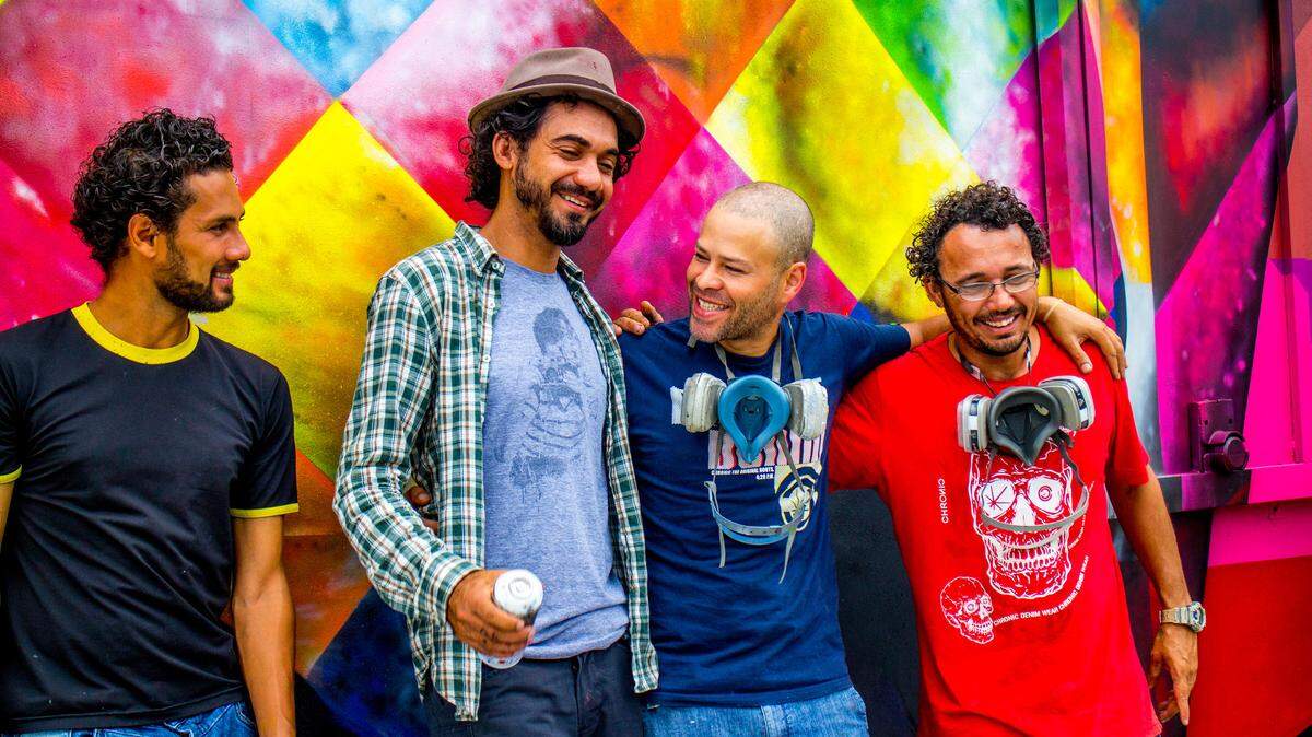 Brazilian artist Eduardo Kobra and crew stand in front of his Wynwood mural during Miami Art Basel in 2013