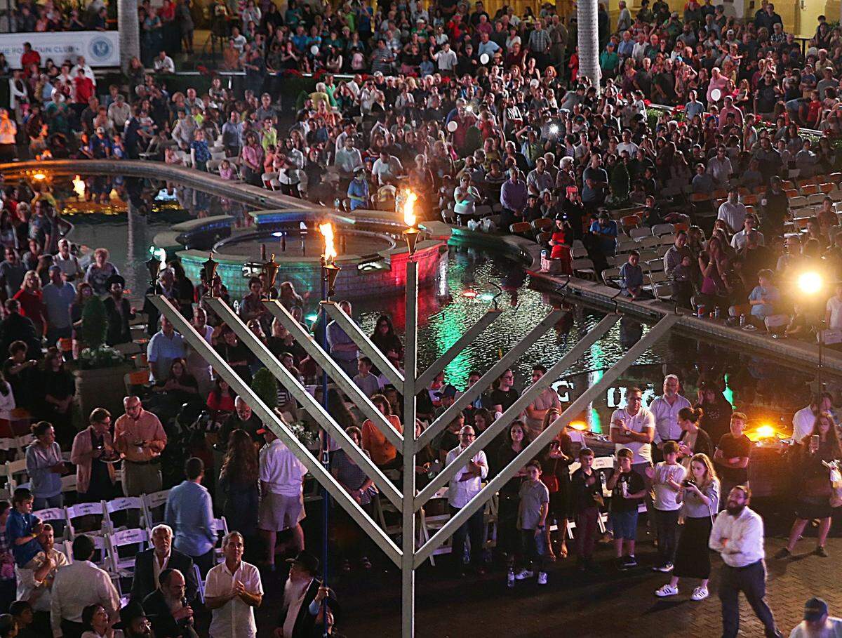Guests look up as Menorah is been light up during the celebration of the 37th annual South Florida Chassidic Chanukah Festival, presented by Friendship Circle of Chabad of South Broward at  Gulfstream Park &amp; Casino Hallandale Beach on Tuesday December 27, 2016.