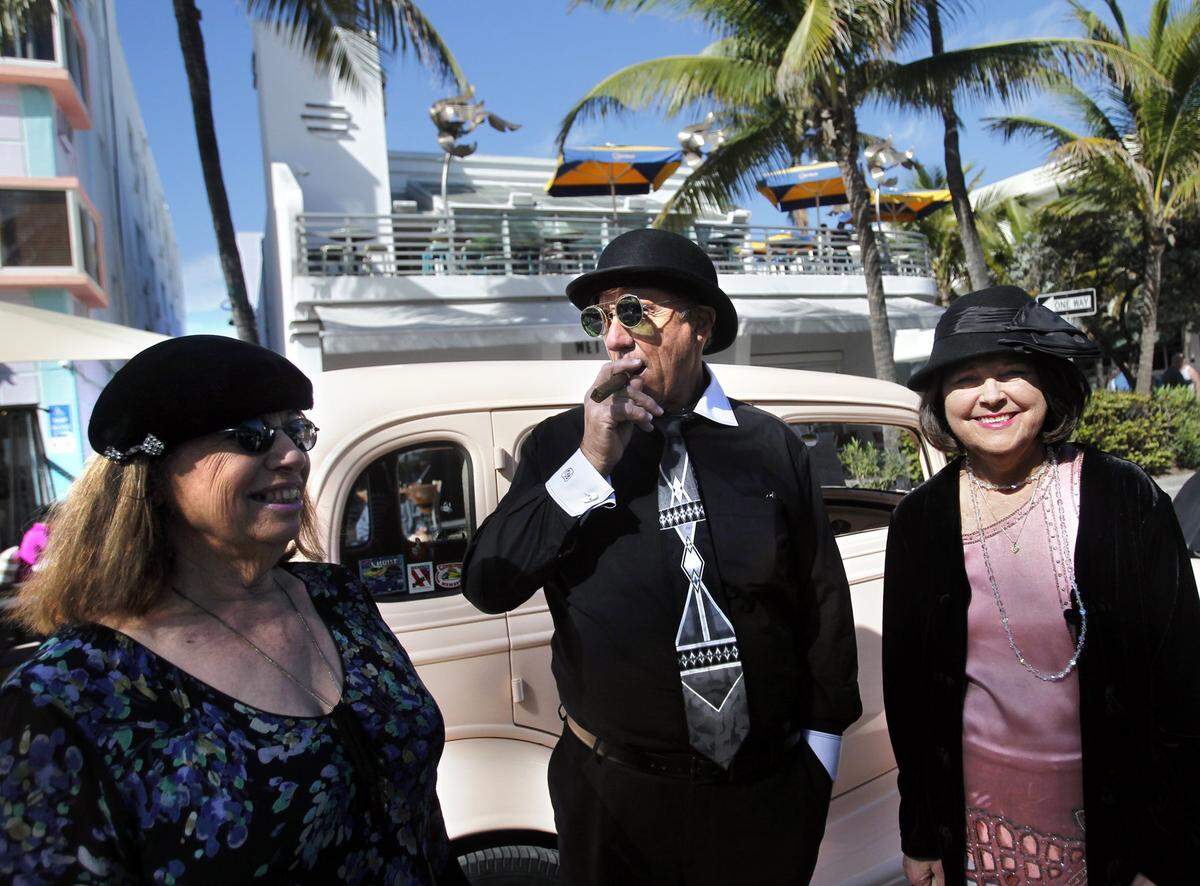 Shirlee and Ron Freitas, left, visiting from Kona, Hawaii, and their friend Carol Humm of Boca Raton look stylish in fashions from the Art Deco era as they take in Art Deco Weekend in Miami Beach.
