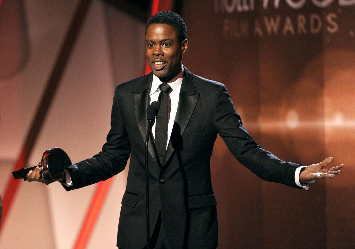 FILE - In this Nov. 14, 2014 file photo, Chris Rock accepts the Hollywood comedy film award on stage at the Hollywood Film Awards at the Palladium in Los Angeles.  The largest black audience for the Academy Awards over the last dozen years came in 2005, when  Rock was host and Jamie Foxx and Morgan Freeman won the top male acting awards. Rock will be back as host this year, on Feb. 28, 2016, but it's an open question how many black viewers will be tuning in. (Photo by Chris Pizzello/Invision/AP)