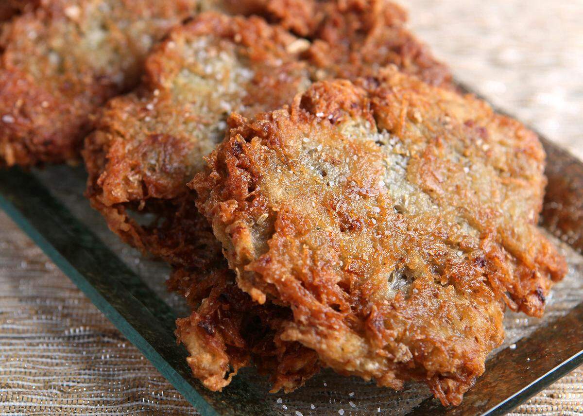 Latkes, also commonly called potato pancakes, are prepared by frying grated potato and onions. (Roberto Rodriguez/St. Louis Post-Dispatch/TNS)