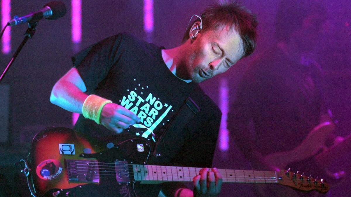 Radiohead's singer and frontman, Thom Yorke, plays guitar during the rock band's performance at the Shoreline Amphitheater in Mountain View, Calif., on Sept. 23, 2003. The groundbreaking British group, already notorious for reinventing its sound with each of its six albums, is preparing for yet another metamorphosis, according to Yorke. (AP Photo/Contra Costa Times, Doug Duran)
