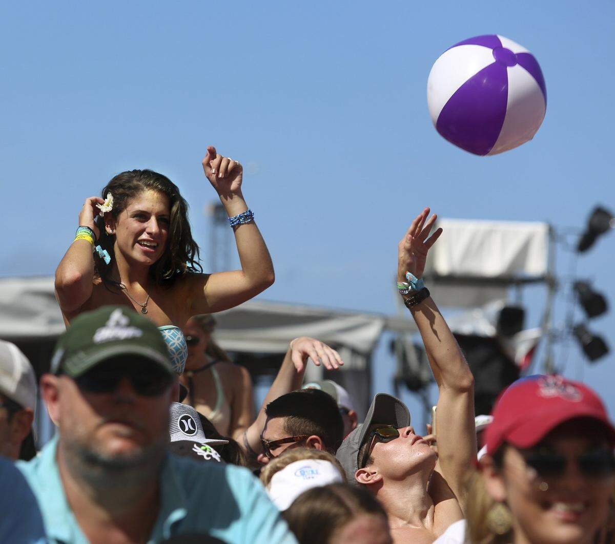 A woman and a beach ball share the space during a concert by country music star Trace Adkins at the 2015 Rock the Ocean's Tortuga Music Festival at Fort Lauderdale Beach Park on Saturday, April 11, 2015. Named for the turtles that nest on that beach, the two-day event continues Sunday, April 12, 2015. Since its 2013 debut, the event has raised nearly $200,000 for marine conservation organizations.