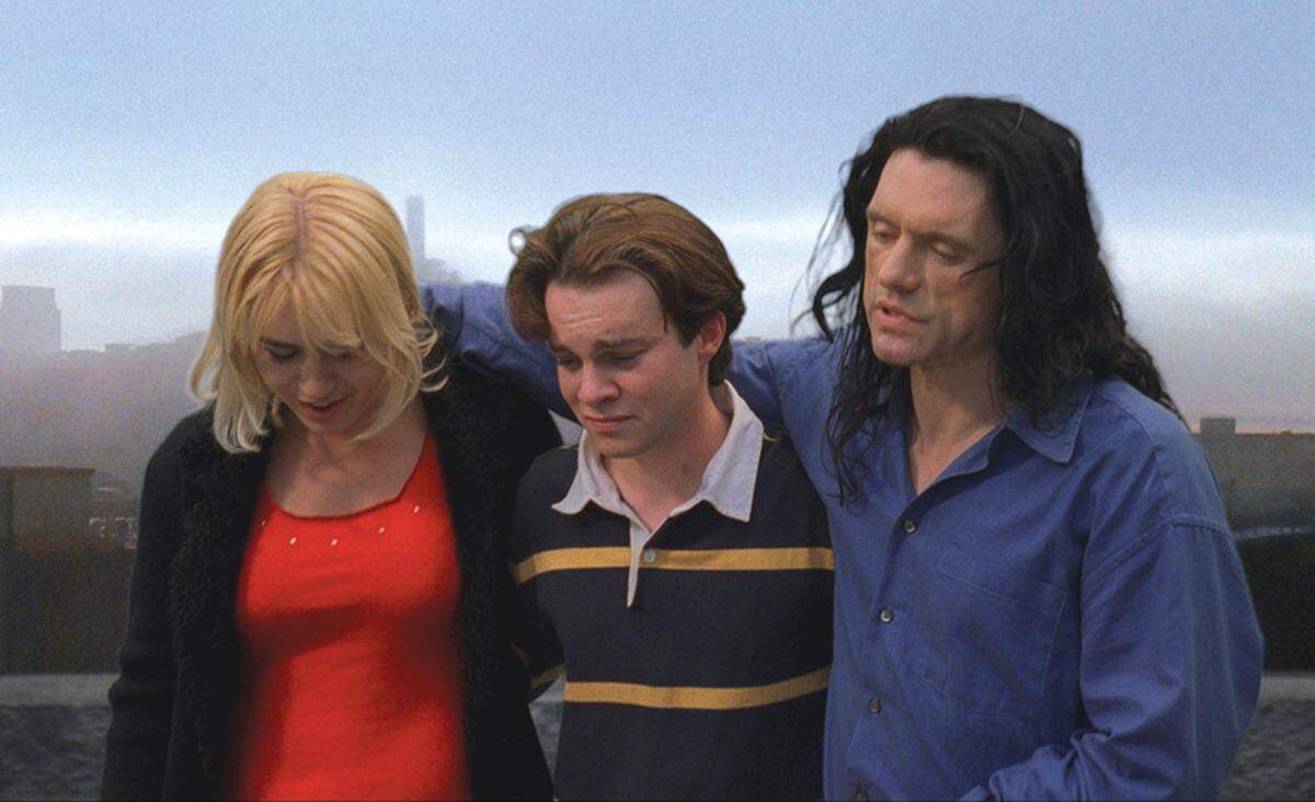 In this film publicity image released by Chloe Productions/TPW Films, Juliette Danielle, left,Philip Haldiman, center, and Tommy Wiseau are shown in a scene from "The Room."  (AP Photo/Chloe Productions/TPW Films)