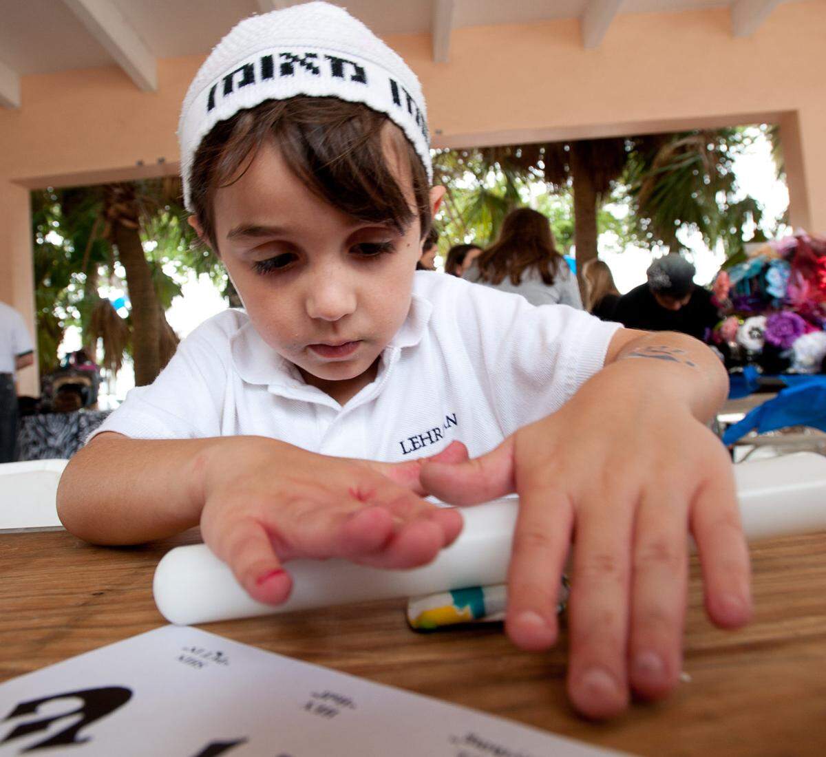 Miami Beach resident Spencer Sabet, 5, makes a dreidel out of clay during the 15th annual Chanukah Festival at North Beach Elementary School, Sunday, Dec. 11, 2011, in Miami Beach. The event also featured a bazaar, a menorah lighting ceremony, bounce houses, and other children's activities.