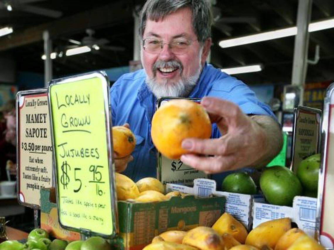 Robert Moehling shows off some fruit at the produce market that bears his name, Robert Is Here.