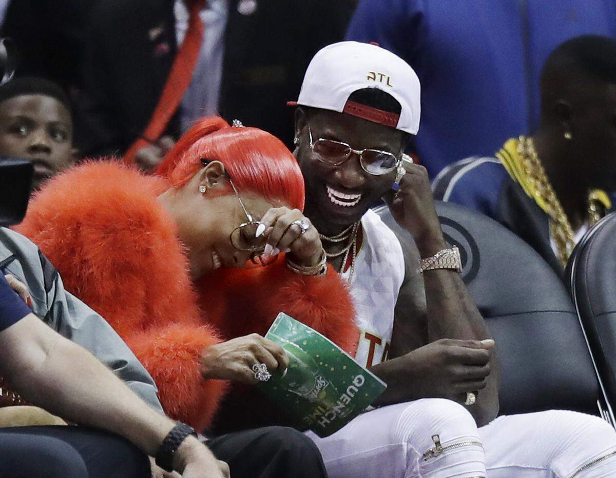 Hip Hop artist Gucci Mane, right, laughs with Keyshia Ka'oir after he proposed to her in the fourth quarter of an NBA basketball game between the Atlanta Hawks and the New Orleans Pelicans in Atlanta, Tuesday, Nov. 22, 2016. (AP Photo/David Goldman)
