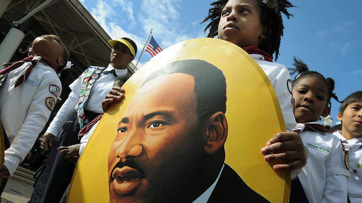 Members of the Southpoint Seventh Day Adventist Church Adventurer and Pathfinder Clubs carry photos of Dr. King during the annual Martin Luther King Jr. Day parade through downtown Jacksonville, Fla., Monday Jan. 16, 2012. (AP Photo/The Florida Times-Union, Kelly Jordan)
