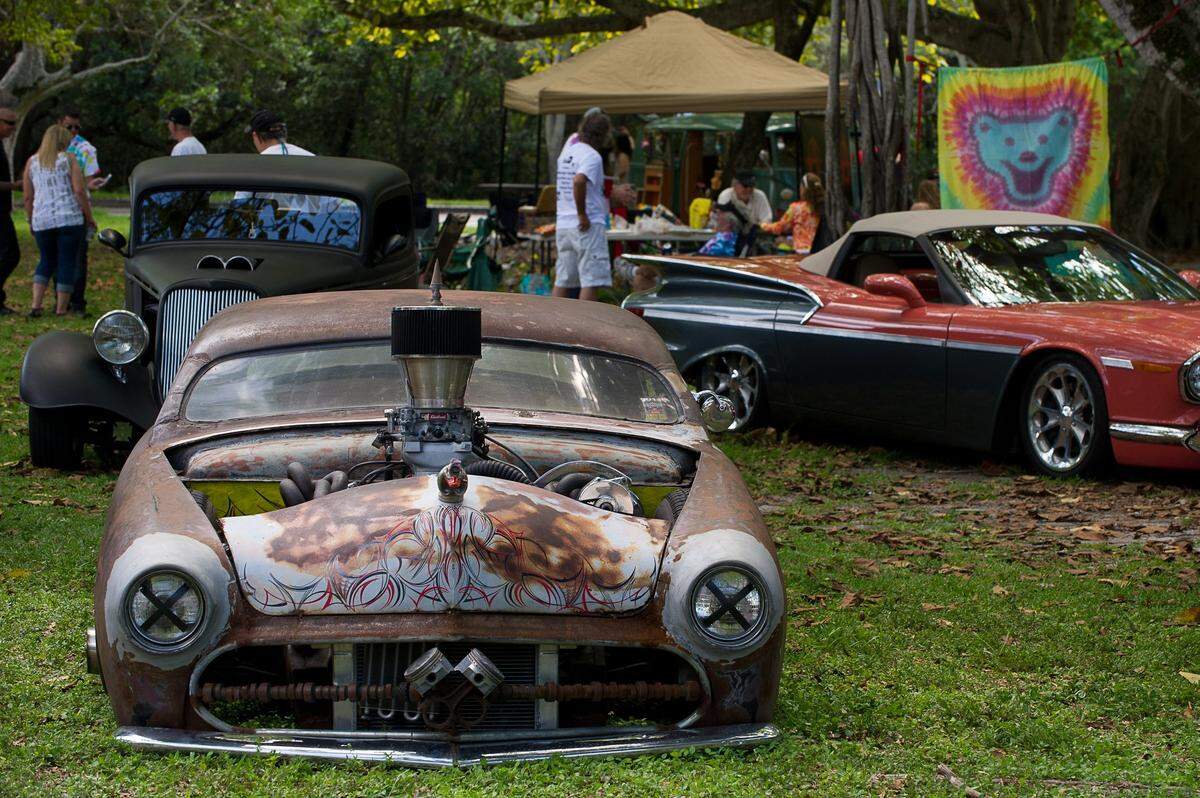 Visitors check out some cars on display during the 12th-annual Love-In Party in the Park at Greynolds Park in North Miami Beach, Sunday, May 3, 2015. More than 1000 people turned out for the music festival, which was presented by Catholic Health Services. The event featured five musical acts, a car show, and vendors of food, arts, and crafts.
