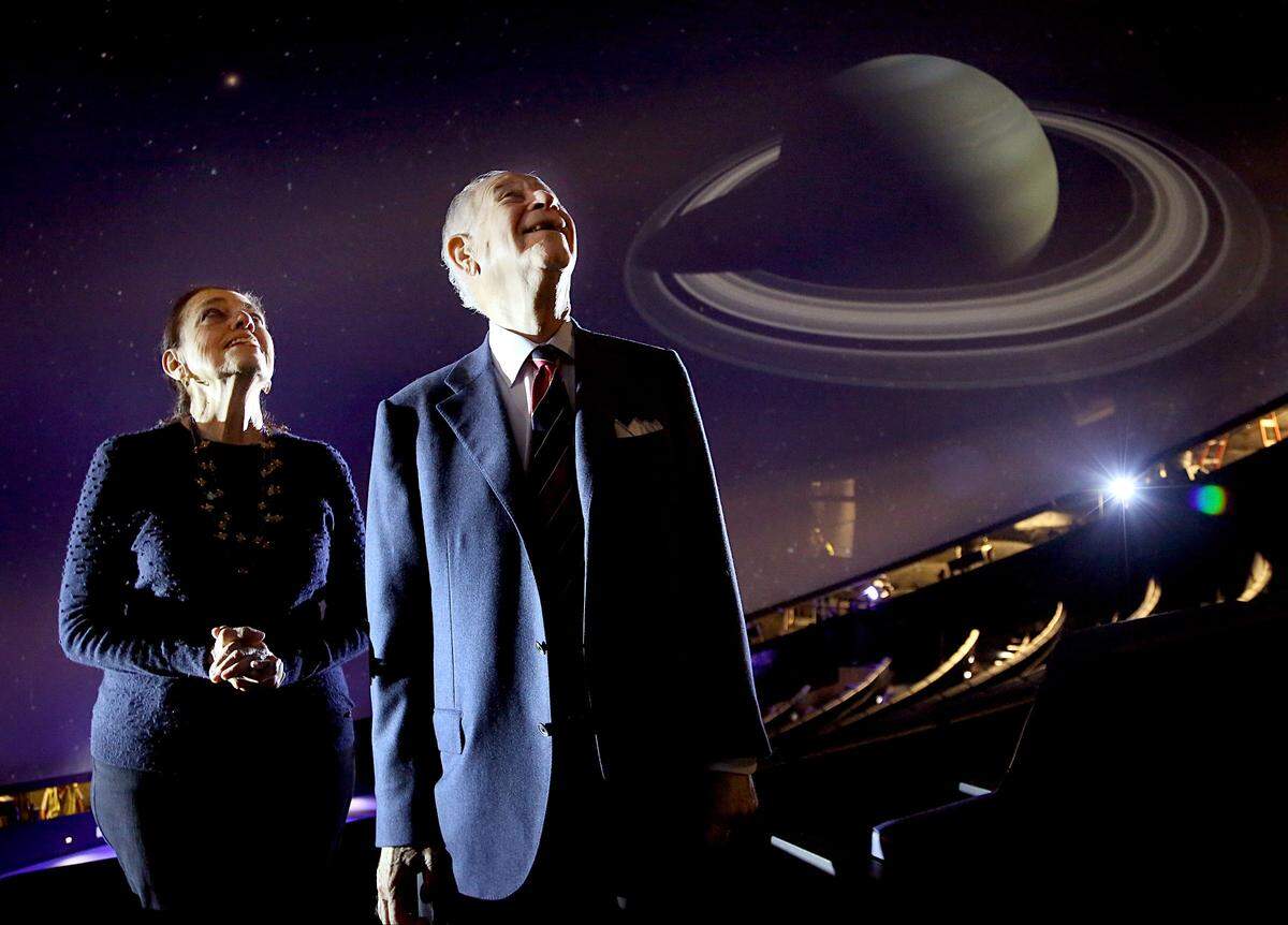 On Tuesday, May 2, 2017 Patricia, left, and Phillip Frost, right, look upward towards the ceiling where planets, moons, and stars are displayed inside Planetarium at the Frost Museum of Science which bears their names.